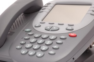 Modern office system phone with large LCD screen.